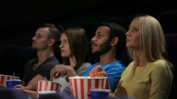 Group of friends watching film in cinema — Stock Video