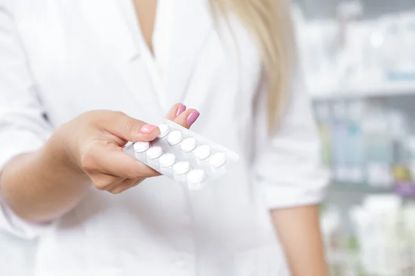 Close up de um farmacêutico segurando pílulas — Fotografia de Stock