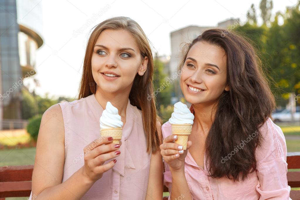 Two friends eating ice cream on the bench Stock Photo by ©photo_oles