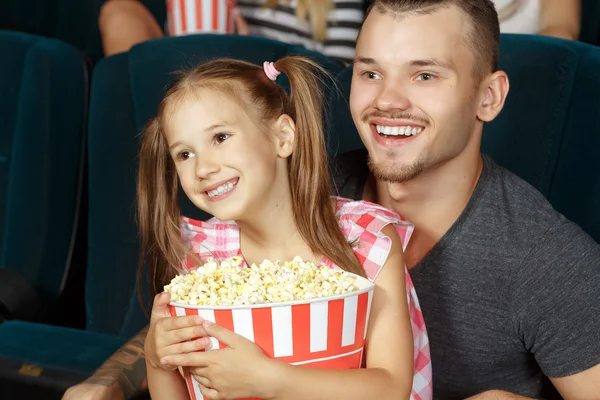 Little girl and her elder brother at the cinema — Stock Photo, Image