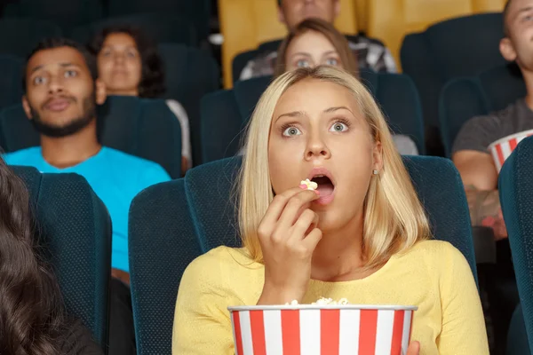 Young girl watching a movie with admiration — Stock Photo, Image