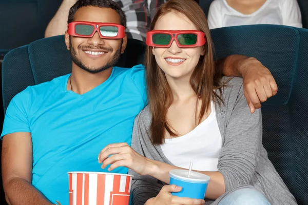 Happy couple watching a movie at the cinema — Stock Photo, Image