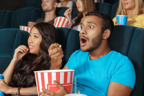 Young man watching a movie with admiration — Stock Photo, Image