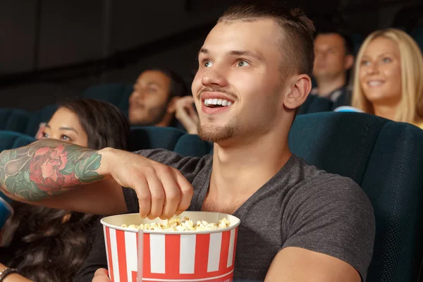 Young man laughing during a comedy film — Stock Photo, Image