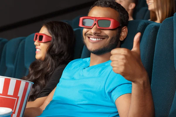 Thumbs up for interesting movie — Stock Photo, Image