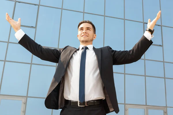 Businessman standing with his arms raised up — Stock Photo, Image