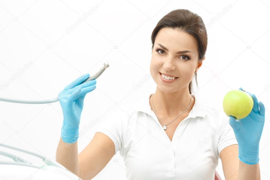 Attractive dentist holding an apple