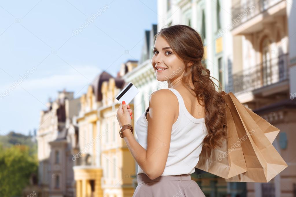 Attractive girl returns home after shopping