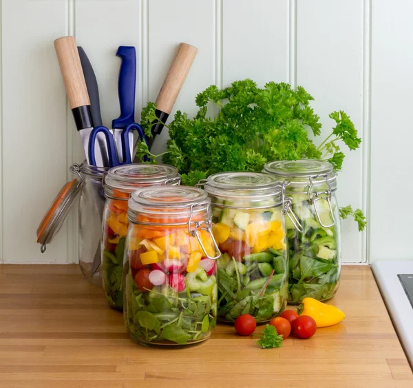 Salad in glass storage jars with utensils. — Stock Photo, Image