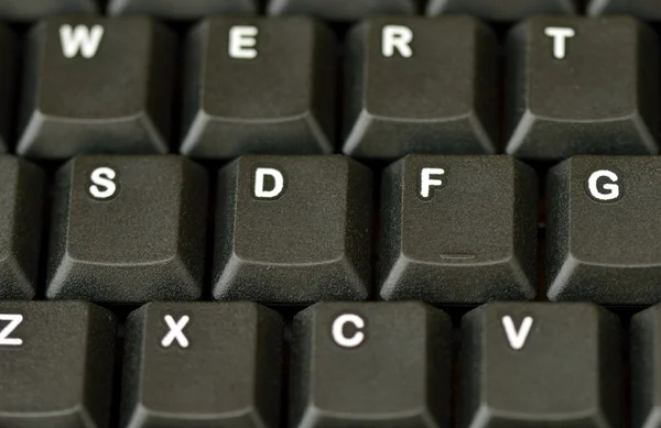 Face on computer keyboard close up. — Stock Photo, Image