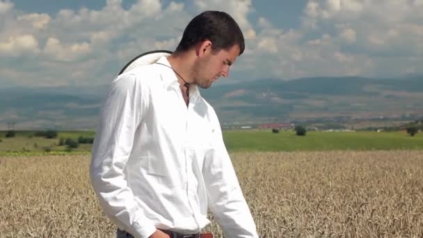 Agricultor a olhar para um conceito de satisfação de trabalho de campo de trigo — Vídeo de Stock