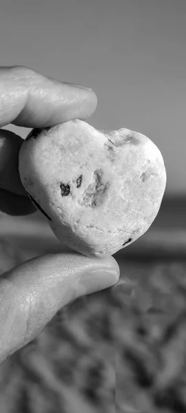 Stone heart in hand. Desktop for phone screensaver
