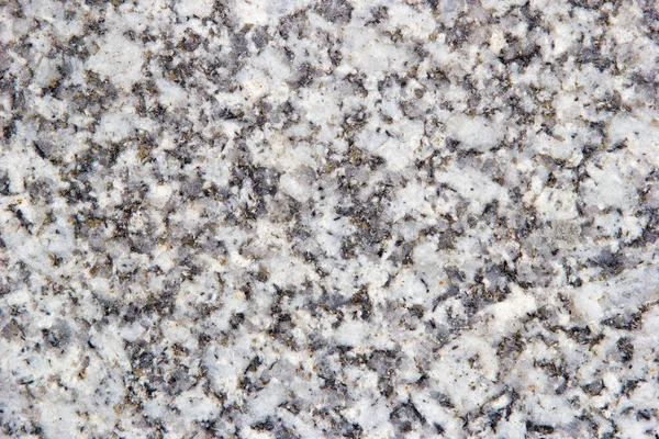 Gray granite with yellow-white inclusions. Granite texture, top view. — Stock Photo, Image