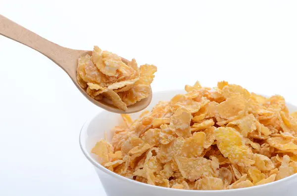 Bowl of cornflakes with a spoon on white background. Healthy Eat Stock Photo