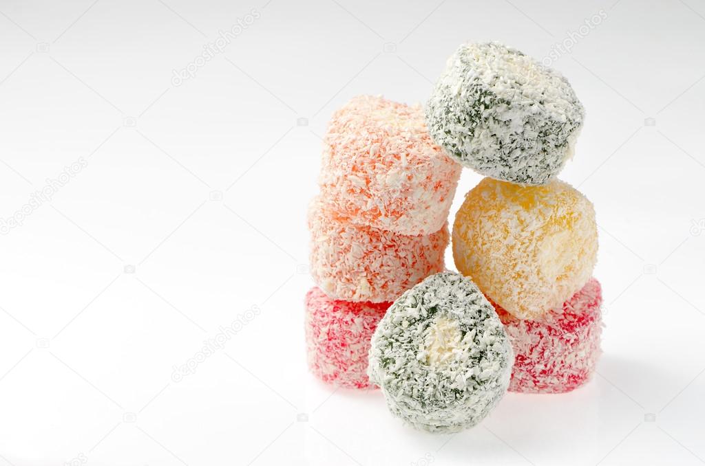 Sweets Turkish Delight, fruit jelly in coconut chips color on a white background