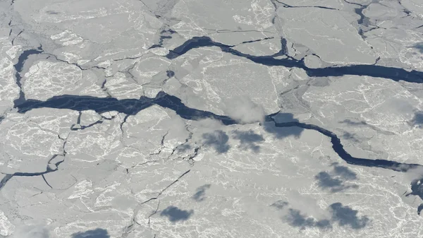 Pęknięcia w polar lądolodu i chmury. widziane z samolotu — Zdjęcie stockowe