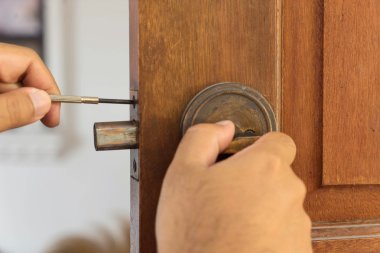 locksmith on wood door for reparing clipart
