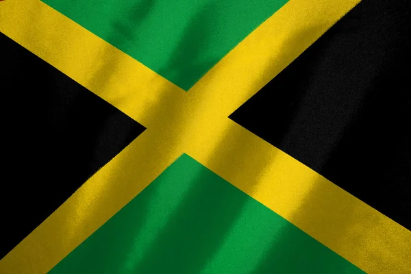 Jamaica vlag op stof achtergrond — Stockfoto