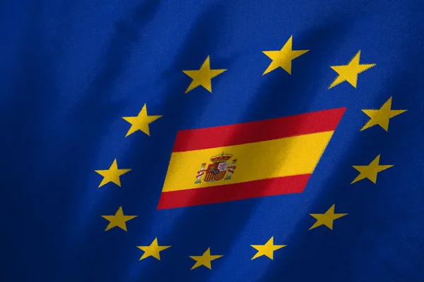 Spanyolország lobogója alatt az Eu-zászló szövet háttér — Stock Fotó