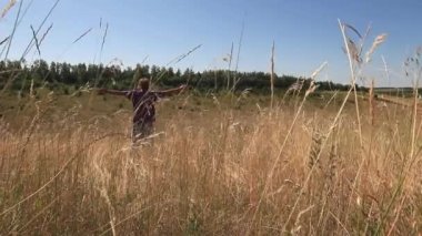 the grass sways in the field, the man falls into the grass