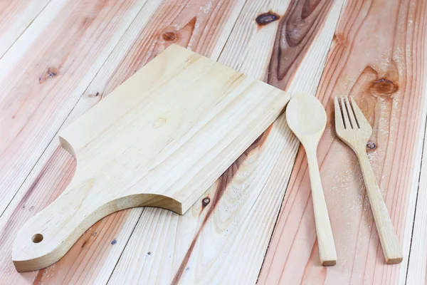 Wooden cutting boards, wooden spoons, wooden forks on wood background — Stock Photo, Image