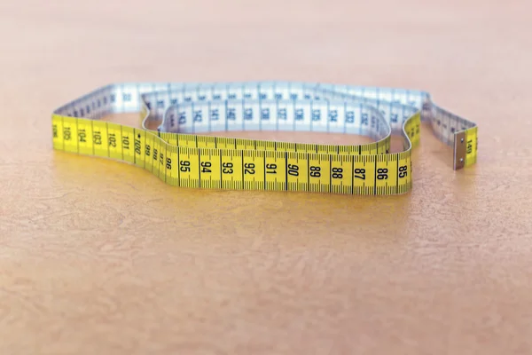 Centimeter tape lying on floor — Stock Photo, Image