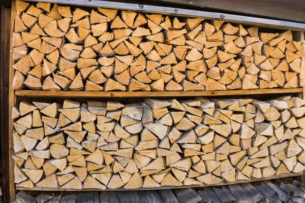 Wall of stacked wood logs — Stock Photo, Image