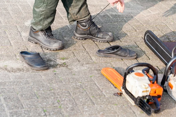 Lumberjack changing shoes Royalty Free Stock Photos