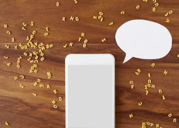 Smartphone, thought bubble, voice command, alphabet noodles, coo — Stock Photo, Image