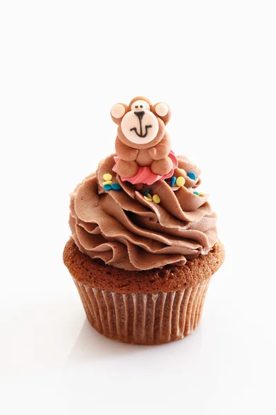 Gros plan de cupcake chocolat crème au beurre avec figurine de singe a — Photo