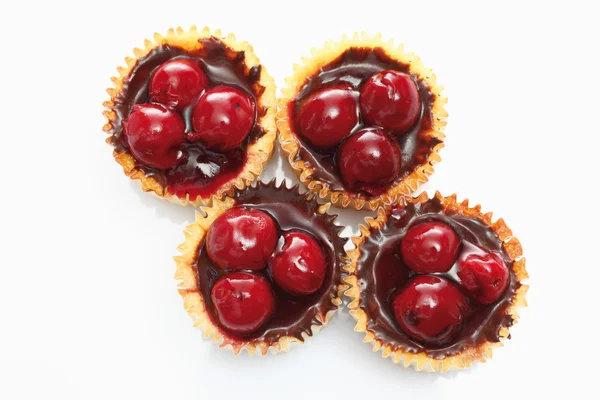 Close up of cupcake topped with chocolate cream and cherries aga — Stock Photo, Image