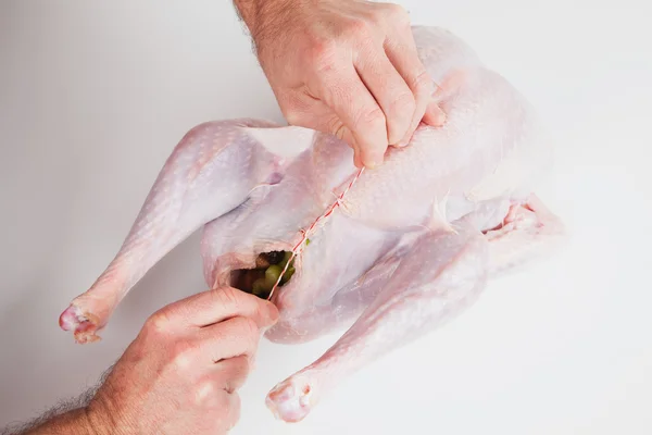 Man stuffing raw turkey, Thanksgiving, Christmas dinner — Stock Photo, Image