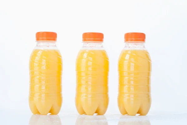 Orange juice bottles on white background,close up — Stock Photo, Image