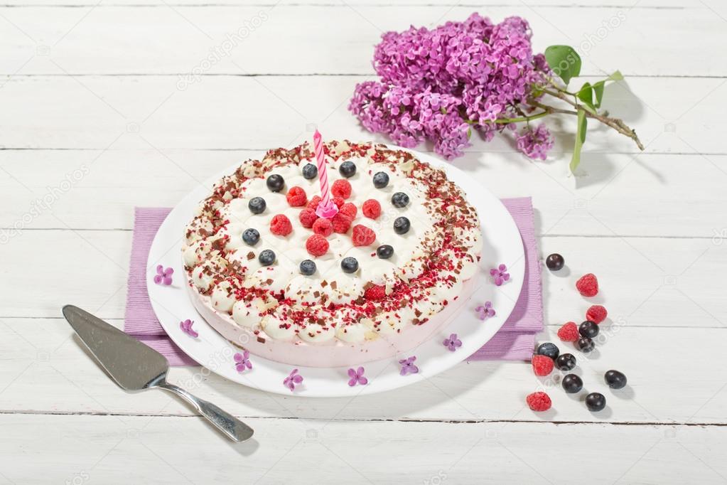 Raspberry-cream cake with raspberries and blueberries