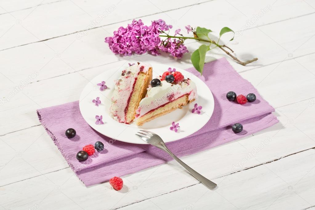 Raspberry-cream cake with raspberries and blueberries