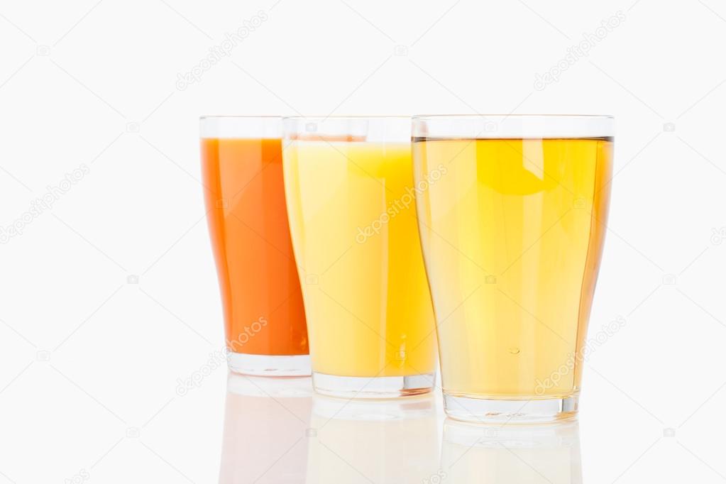 Variety of juices in glass on white background