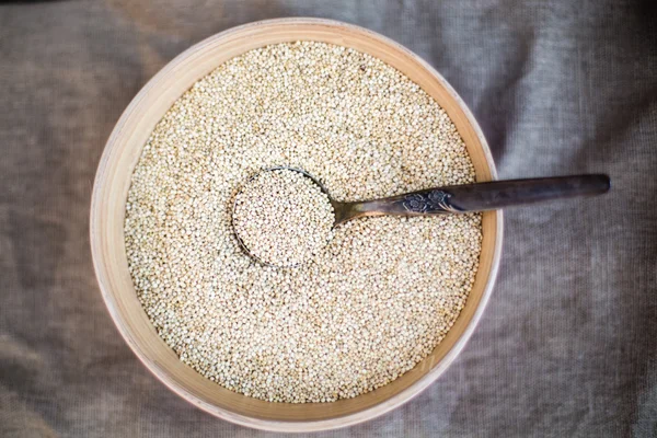 Organic quinoa grain in wooden bowl — Stock Photo, Image