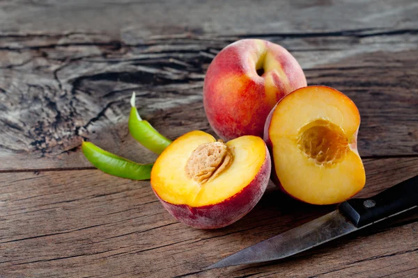 Peaches on wood, chopped — Stock Photo, Image