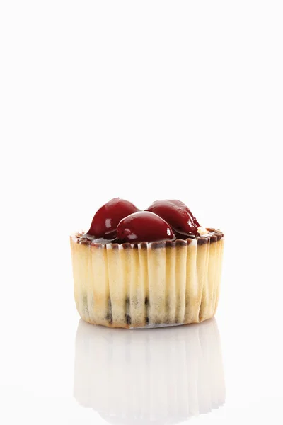 Close up of cupcake topped with chocolate cream and cherries aga — Stock Photo, Image