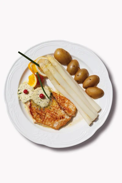 Close up of turkey steak with asparagus,herb butter and potatoes — Stock Photo, Image