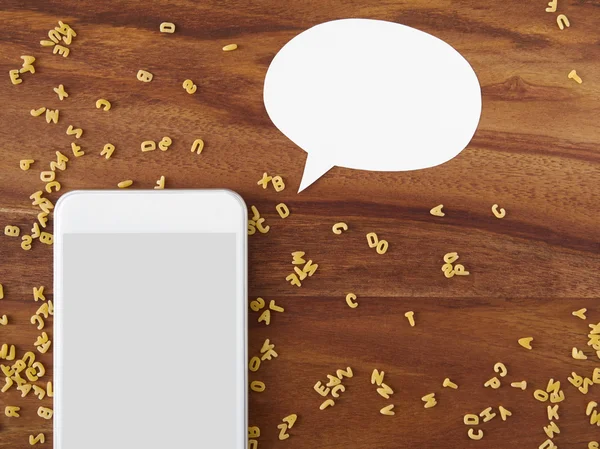 Smartphone, thought bubble, voice command, alphabet noodles, coo — Stock Photo, Image