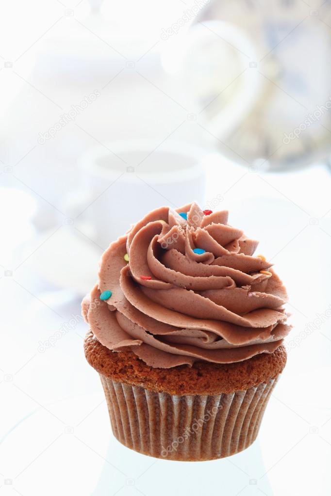 Close up of buttercream chocolate cupcake against white backgrou