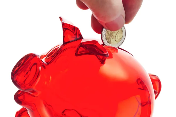 Person putting Euro coin into piggy bank — Stock Photo, Image