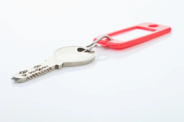 Key with key ring on white background — Stock Photo, Image