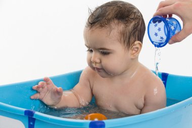 Female baby bathing in bathtube clipart