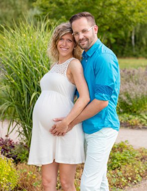 Mutlu çift bekliyor bebek, parkta duran