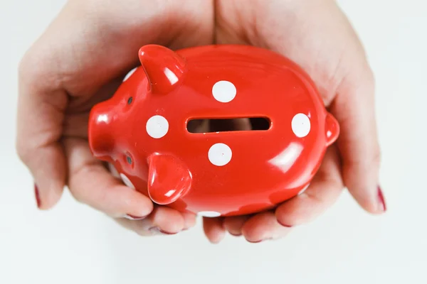 Woman holding red piggy bank — Stock Photo, Image