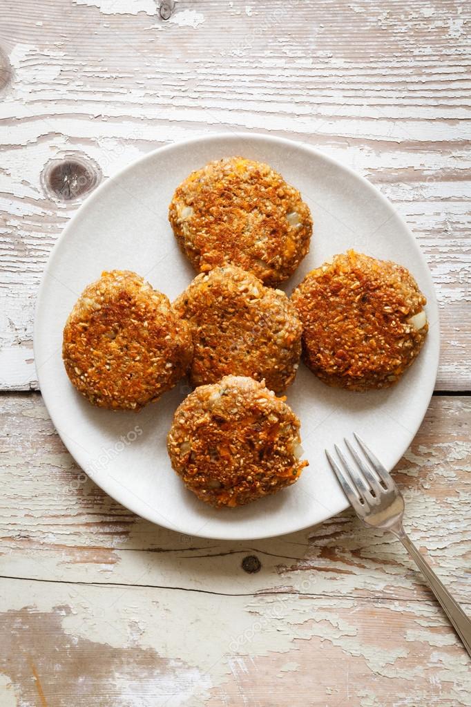 Vegetarian spelt patties with carrot on plate