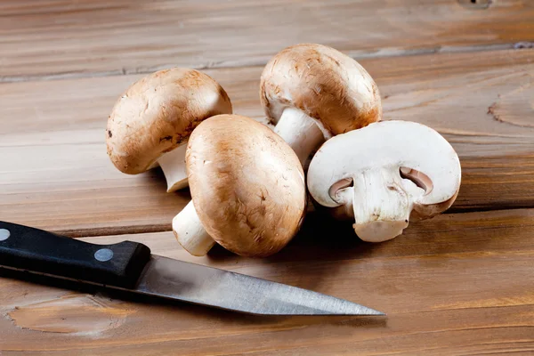 Mushrooms on wood, knive, chopped — Stock Photo, Image