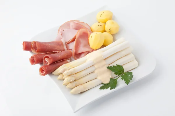 Asparagus,potatoes,parma ham and parsley in plate on white backg — Stock Photo, Image